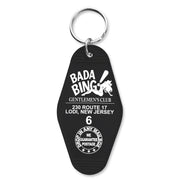 A black keychain with 'BADA BING GENTLEMEN'S CLUB' printed on it and the address 230 ROUTE 17 LODI, NEW JERSEY. There is also a graphic of a mobster and the number 6, referencing the show 'The Sopranos'.